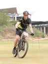 Happy middle aged man riding to the finish line at Mountain Bike
